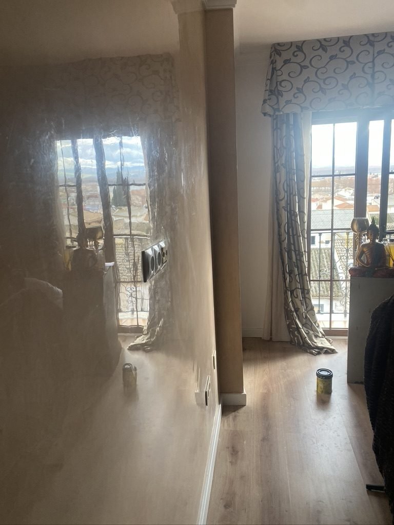 Pared de estuco pulido y brillante que refleja la luz de la ventana